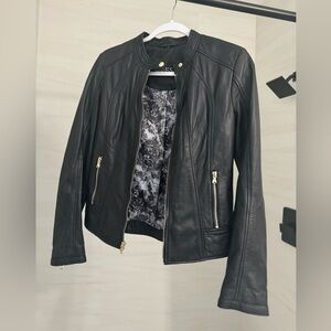 Beautiful black leather jacket by Guess. Barely worn. Silly floral inside.